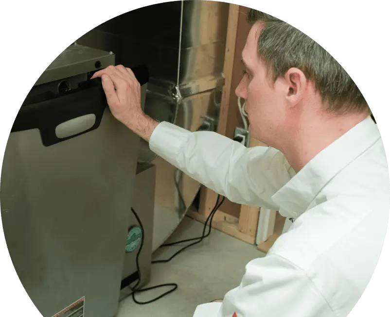 Furnace_Installation_Banner An AtlasCare technician repairs an air conditioning unit, using specialized tools to service the system's components.