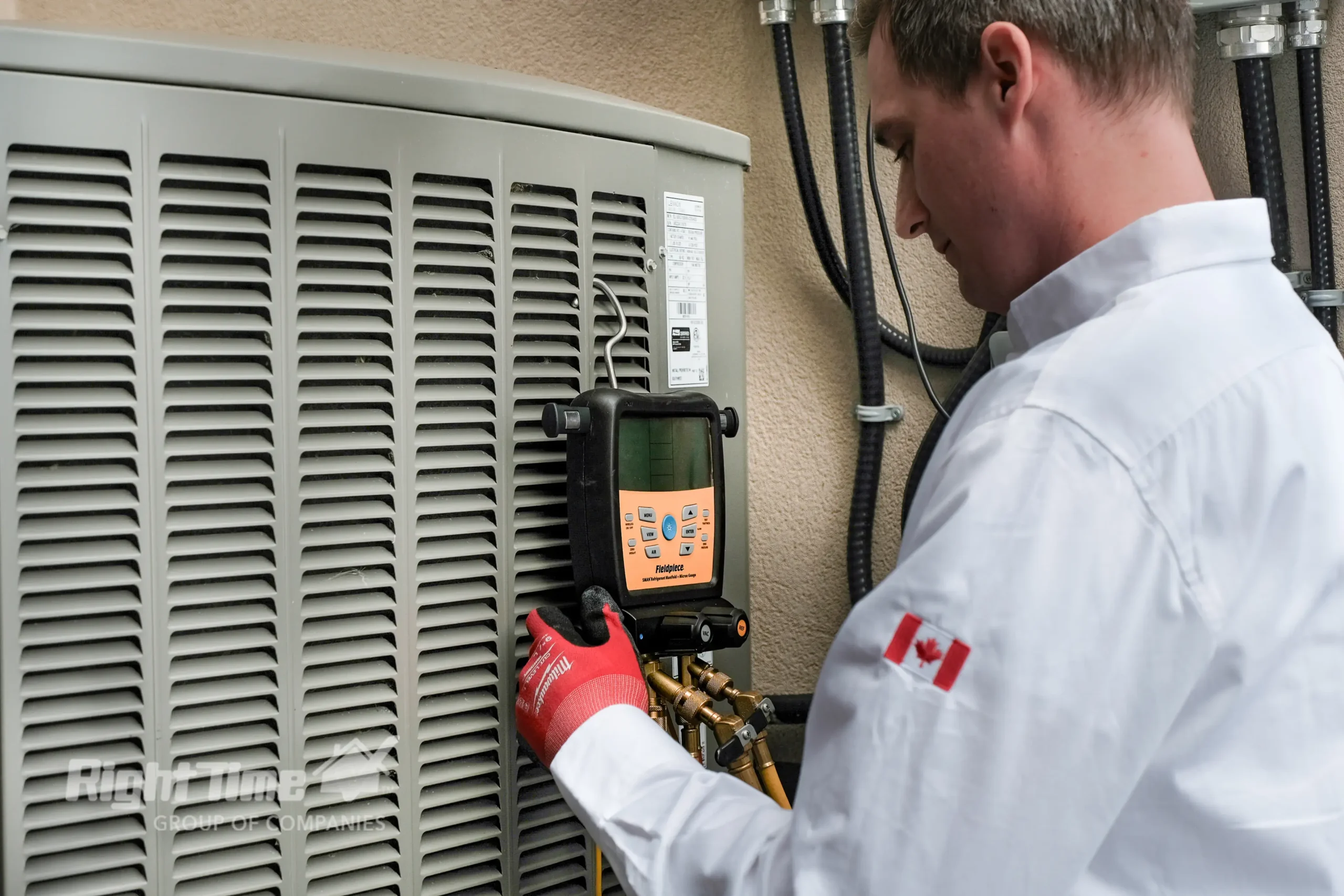 Technician servicing heat pump outside Ontario home during winter, ensuring efficient heating and cooling.